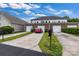 Townhome with private garages and driveways, complemented by green landscaping at 6011 Nw Village Nw Dr, Concord, NC 28027