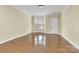 Spacious living room featuring hardwood floors, natural light, and neutral paint for versatile decor at 6011 Nw Village Nw Dr, Concord, NC 28027