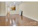 Open-concept living space with hardwood flooring and ample natural light in a well-maintained home at 6011 Nw Village Nw Dr, Concord, NC 28027