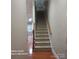 Carpeted staircase with wooden railings leads to the upper level at 6011 Nw Village Nw Dr, Concord, NC 28027