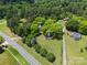 Aerial view of two houses nestled among lush greenery, showcasing the expansive property from above at 615 & 625 Irish Potato Rd, Concord, NC 28025