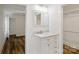 Bright bathroom with a marble vanity, framed mirror, and storage at 615 & 625 Irish Potato Rd, Concord, NC 28025