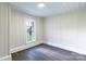 Cozy bedroom with wainscoting, a window letting in natural light, and stylish gray floors at 615 & 625 Irish Potato Rd, Concord, NC 28025