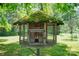 A unique birdhouse covered in moss, surrounded by lush greenery and a satellite dish in the background at 615 & 625 Irish Potato Rd, Concord, NC 28025