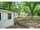 Exterior view of the house and its charming setting with mature trees and a well-manicured lawn at 615 & 625 Irish Potato Rd, Concord, NC 28025