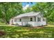 A wide shot of the side of a well-maintained house, showcasing a lush green lawn at 615 & 625 Irish Potato Rd, Concord, NC 28025