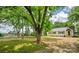 Charming white home with dark shutters, lush trees, and a separate guest house on a sunny day at 615 & 625 Irish Potato Rd, Concord, NC 28025