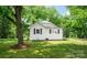 Landscaped yard framing a white house with black shutters and mature shade trees at 615 & 625 Irish Potato Rd, Concord, NC 28025