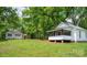Exterior shot showcasing the house and a separate building, highlighting the property's size and potential at 615 & 625 Irish Potato Rd, Concord, NC 28025