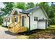 Side view of home displaying new entryway, vinyl siding, and fresh landscaping at 615 & 625 Irish Potato Rd, Concord, NC 28025