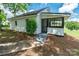 Charming exterior showcasing a ramp and screen porch, surrounded by lush greenery at 615 & 625 Irish Potato Rd, Concord, NC 28025