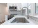 Modern kitchen with stainless steel appliances, including microwave, faucet and oven with mosaic backsplash at 615 & 625 Irish Potato Rd, Concord, NC 28025