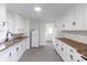 Functional kitchen features white cabinetry, butcher block countertops and ample storage at 615 & 625 Irish Potato Rd, Concord, NC 28025