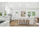 Modern kitchen features an island with seating, stainless steel appliances, and new backsplash at 615 & 625 Irish Potato Rd, Concord, NC 28025