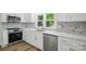 Modern kitchen features new stainless steel appliances, quartz countertops, and mosaic backsplash at 615 & 625 Irish Potato Rd, Concord, NC 28025