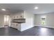Open-concept living space with plank flooring, and classic white cabinets and trim at 615 & 625 Irish Potato Rd, Concord, NC 28025