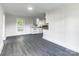 Open living room and kitchen with white walls, plank flooring and natural light at 615 & 625 Irish Potato Rd, Concord, NC 28025