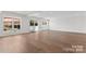 Spacious basement area featuring wood-look floors, recessed lighting, and sliding glass doors to the outside at 621 Poindexter Dr, Charlotte, NC 28209