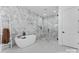 Luxurious bathroom featuring a freestanding tub, glass shower, and marble accents at 621 Poindexter Dr, Charlotte, NC 28209