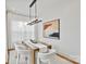 Bright dining room with modern chandelier, abstract art, and seating for six at 621 Poindexter Dr, Charlotte, NC 28209