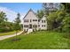 Stunning two-story home with manicured lawn, mature trees, and a contemporary facade at 621 Poindexter Dr, Charlotte, NC 28209