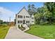 Beautifully landscaped home with a manicured front yard, elegant driveway and inviting entrance at 621 Poindexter Dr, Charlotte, NC 28209