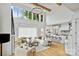 Open-concept living room with large windows, hardwood floors, modern furnishings, and seamless kitchen access at 621 Poindexter Dr, Charlotte, NC 28209