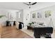 Bright living room with hardwood floors, a ceiling fan, and multiple windows with a comfortable seating area at 621 Poindexter Dr, Charlotte, NC 28209