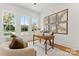 Well-lit home office featuring hardwood floors, natural light, and ample workspace at 621 Poindexter Dr, Charlotte, NC 28209
