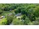 A scenic aerial view showcasing the property nestled among dense, mature trees with water access at 6256 Monford Dr, Conover, NC 28613