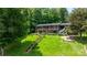 A spacious two-story home with an expansive backyard, landscaped stairs, and a fire pit area, ideal for outdoor gatherings at 6256 Monford Dr, Conover, NC 28613
