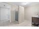 Bathroom featuring white-painted brick walls, tiled floors, and a shower with glass doors at 6256 Monford Dr, Conover, NC 28613