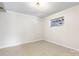 Bedroom with tile floor, cream colored walls, and a small window at 6256 Monford Dr, Conover, NC 28613