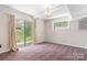 Bright bedroom with sliding glass doors to the backyard, soft carpeting, and natural light creates a cozy retreat at 6256 Monford Dr, Conover, NC 28613