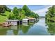 Waterfront property featuring multiple private boat houses on a serene lake surrounded by lush greenery and scenic views at 6256 Monford Dr, Conover, NC 28613