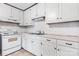 This kitchen features white cabinets, modern appliances, and a functional layout for easy meal preparation and dining at 6256 Monford Dr, Conover, NC 28613