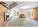 Relax in this living room featuring a stone fireplace, plush carpeting, and doors leading to the outdoors at 6256 Monford Dr, Conover, NC 28613