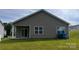 Rear exterior of home features vinyl siding, a covered patio, and view of the backyard at 640 Yellow Birch Dr, Locust, NC 28097