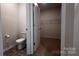 Well-lit bathroom featuring modern toilet and walk-in closet with ample shelving at 640 Yellow Birch Dr, Locust, NC 28097