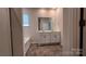 Bathroom showcasing dual vanities, mirrors and tile flooring at 640 Yellow Birch Dr, Locust, NC 28097