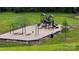 Community playground area with swings, slides, and benches at 640 Yellow Birch Dr, Locust, NC 28097