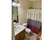 This bathroom features a sink with wooden cabinets and a shower at 667 Blossom Hill Rd, Lincolnton, NC 28092