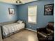 This bedroom features a comfortable single bed and a relaxed sitting area at 667 Blossom Hill Rd, Lincolnton, NC 28092