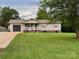 Charming single-story home featuring a well-manicured front lawn and a spacious driveway at 667 Blossom Hill Rd, Lincolnton, NC 28092