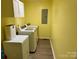The laundry room features a washer, a dryer, and additional storage space at 667 Blossom Hill Rd, Lincolnton, NC 28092
