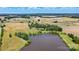 Aerial view of a home with a pond and agricultural fields in the background at 7204 E 218 Hwy, Marshville, NC 28103