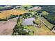 Breathtaking aerial view of a large pond surrounded by beautiful rural countryside at 7204 E 218 Hwy, Marshville, NC 28103