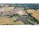 Expansive aerial view of a rural property with a large pond and surrounding farmland at 7204 E 218 Hwy, Marshville, NC 28103