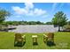 Scenic backyard featuring lawn furniture and waterfront lake views at 7204 E 218 Hwy, Marshville, NC 28103