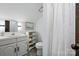 Cozy bathroom with white fixtures, shelving, and a shower featuring a curtain at 7204 E 218 Hwy, Marshville, NC 28103